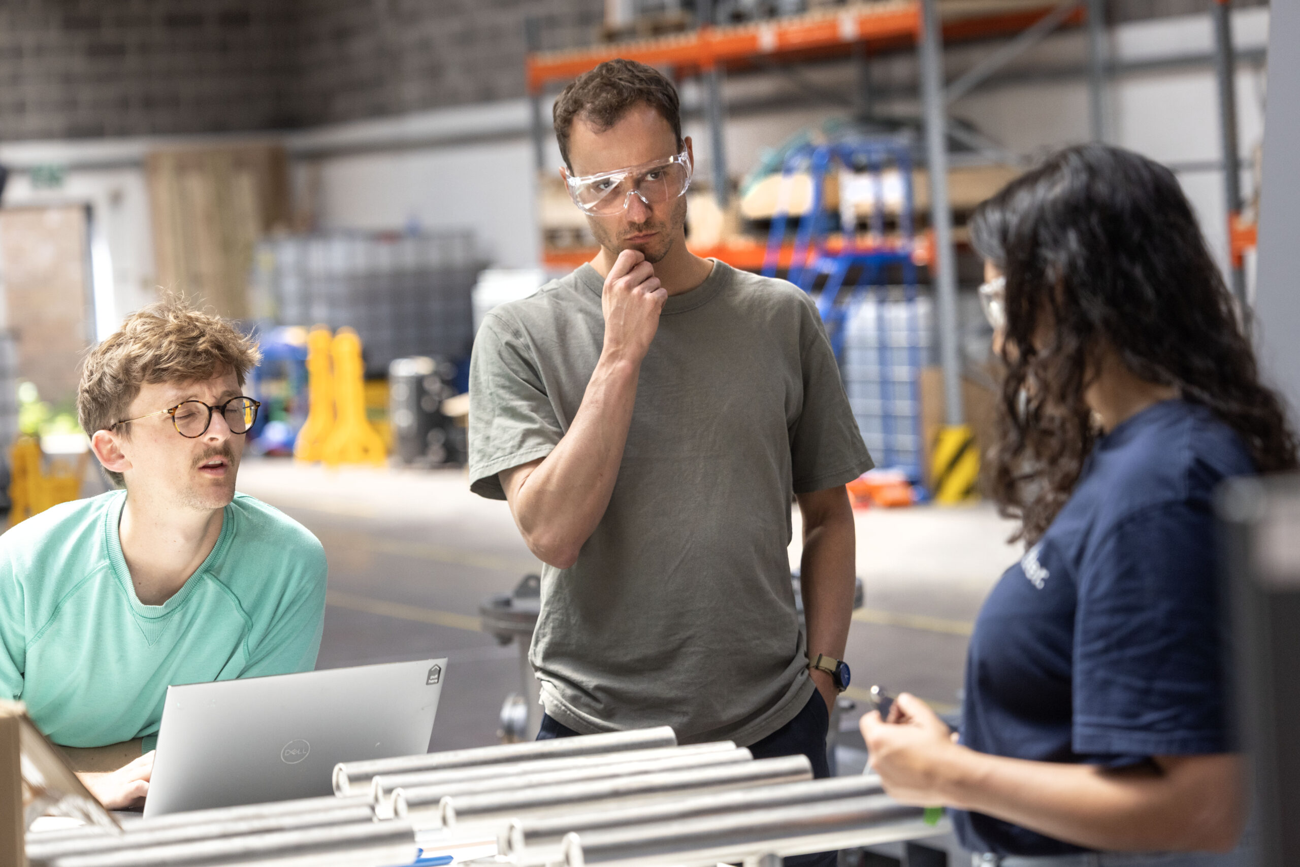 Team gathered around workbench